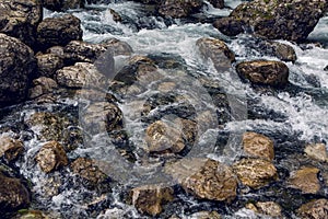 Rapid stream with rocks and moss