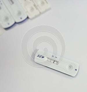 Rapid test kit for AFP or Alfa-fetoprotein testing, showing positive result, tumor or cancer marker for liver. photo