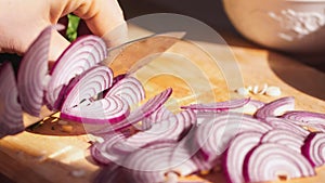 Rapidly Chopping Onion, Close-Up. Slow mothion. red onions close up. Female hands cut onions in kitchen. Macro shooting