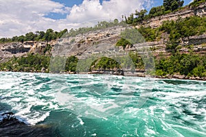Rapids in the Niagara River near the so called whirlpool at the nagar falls. The river winds through the high gorges with immense