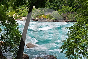 Rapids in the Niagara River near the so called whirlpool at the nagar falls. The river winds through the high gorges with immense