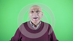 Raptured old man wearing eyeglasses smiling with enthusiasm