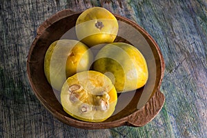 Rare araza fruits in a wooden bowl