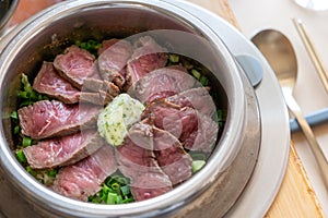 Rare beef rice in a steamed pot with butter.