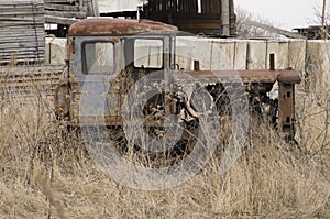 Rare crawler tractor cultivator stands abandoned in the grass