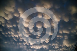 Rare mammatus cotton ball clouds on the back end of the severe thunderstorm photo