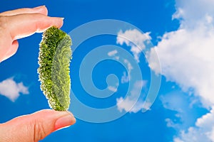 Rare moldavite semi precious stone on blue sky background