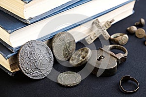 Rare old coins of the Russian Empire on a fabric background and other old objects of the 19th century