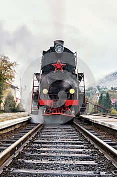 Rare steam train locomotive preparing for departure from railway station, vertical image