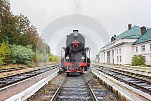 Rare steam train locomotive at the small railway station