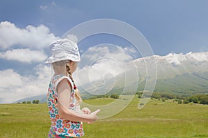 Rare view of Caucasian girl in Italian Apennines of Abruzzi region looking at mountains