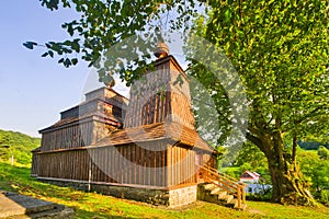 Wooden church of Saint Michael the Archangel in Prikra during summer sunset