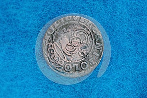 rarity silver coin on blue woolen cloth