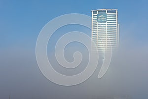 Ras Al Khaimah City in the United Arab Emirates in the early morning fog. Julphur Towers, RAK Properties, peeks above the clouds