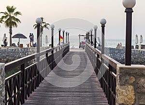 Ras Al Khaimah, UAE - 04.04.2022 - Wooden bridge leading to the beach at The Cove Rotana Resort. Holiday