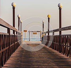 Ras Al Khaimah, UAE - 04.04.2022 - Wooden bridge leading to the beach at The Cove Rotana Resort. Holiday