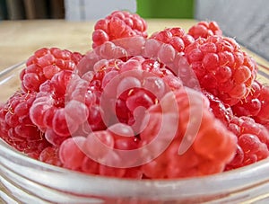 The rasberry on the white table.