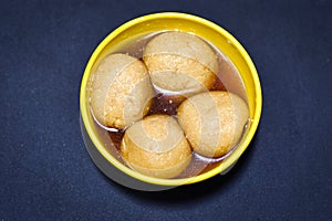 Rasgulla indian favorite sweet in a yellow bowel