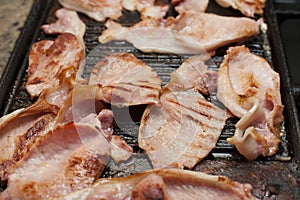 Rashers of smoked bacon on a griddle photo