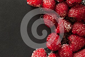 Raspberries on a black background