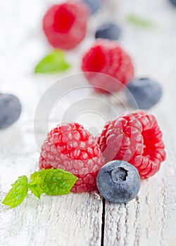 Raspberries and blueberries on white