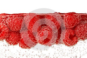 Raspberries in carbonated water isolated on white