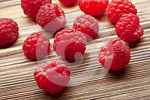 Raspberries close up on wooden worktop