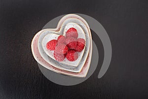 Raspberries displayed in a heart shaped dish