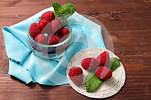 Raspberries in a glass container and on a string circle photo