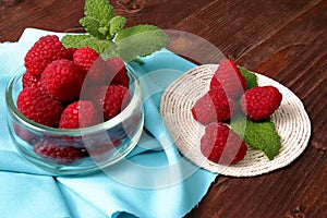 Raspberries in a glass container and on a string circle