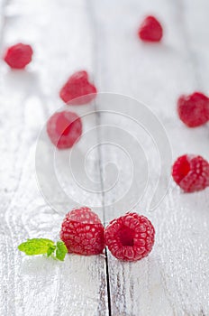 Raspberries with mint on white