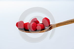 Raspberries on an old wooden spoon