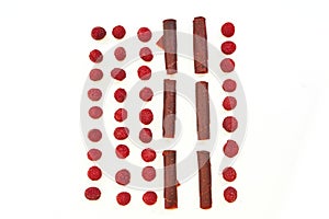 Raspberries and pastilles on a white background close up