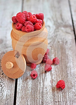 Raspberries in a pot on the table, selective focus