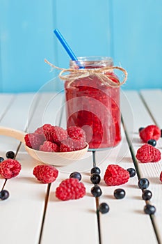 Raspberries in wood spoon. Crimson raspberry and