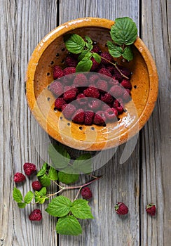 Raspberries  in a yellow bowl