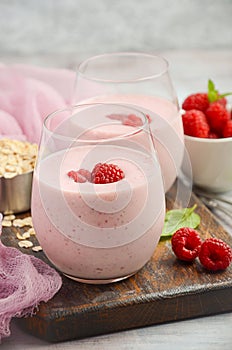 Raspberry and banana smoothie with oatmeal on the rustic wooden table