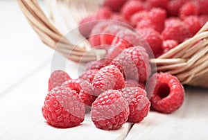 Raspberry in a basket on the table in the garden