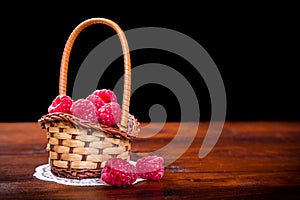 raspberry in basket on wood table