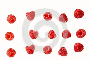 Raspberry berries isolated on a white  in a chaotic manner