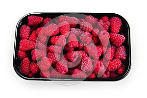 Raspberry in black container isolated on white background