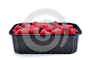 Raspberry in black container isolated on white background