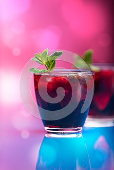 Raspberry and blackberry cocktail with mint garnish.