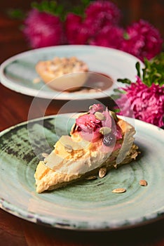 Raspberry cake in Ukrainian style served on a ceramic plate over rustic wooden Ukrainian table.