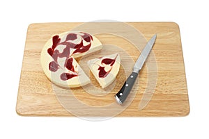 Raspberry cheesecake on a board