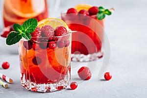 Raspberry Cranberry Sangria Punch or Mojito in glass with orange slices and mint