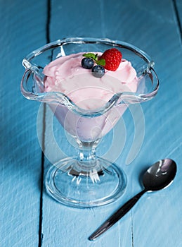 Raspberry cream dessert with mint and fruits