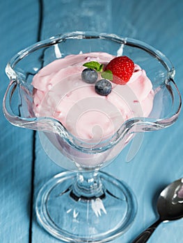 Raspberry cream dessert with mint and fruits