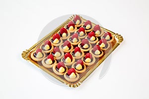 Raspberry cupcakes in a tray on white background