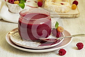 Raspberry curd, raspberries and meringue roll on a light background. Rustic style.